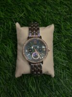 F🔥ssil dual tone chain watch with a green dial for women
